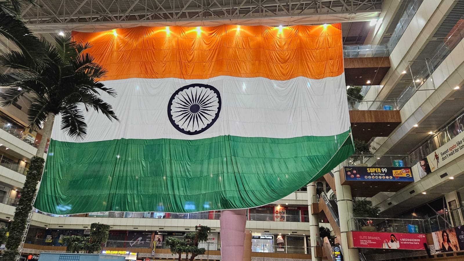 Giant indoor national flag suspended in the atrium of Gaur City Mall, Noida